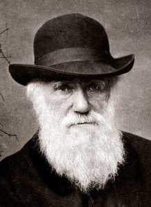 Charles Darwin resting against pillar covered with vines.