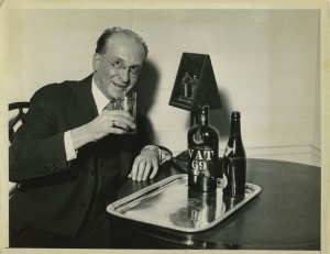 Black and white photograph depicting prominent author Benjamin DeCasseres just before taking the first legal drink at the Waldorf=Astoria on Park Avenue in 1933. By arrangement of United Press, Mr. DeCasseres waited in one of the Hotel's private suites until the moment repeal was signed in Salt Lake City, Utah, whereupon the bon vivant was ready to take the first drink.