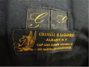 Figure 9. Cotrell & Leonard label on the interior of Santayana’s gown; notice the faded initials “G.S.” above the brand name. [Image credit: Kristin Lee]